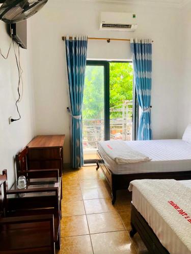 a bedroom with two beds and a window at Thanh Dat 2 Hotel in Vinh