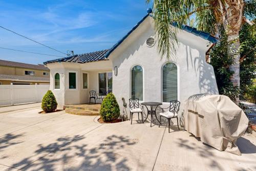 a house with a table and chairs in front of it at Sunshine Fun Time in Newport Beach