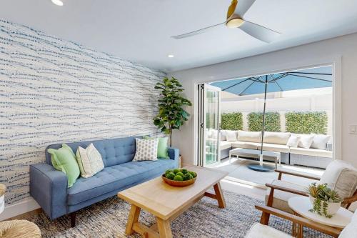 a living room with a blue couch and a table at Mickey's Hideaway in Anaheim