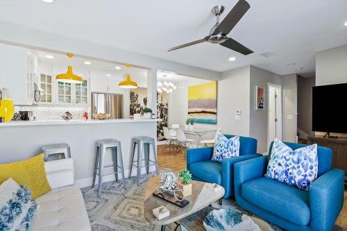 a living room with blue couches and a kitchen at Mickey's Corner in Anaheim