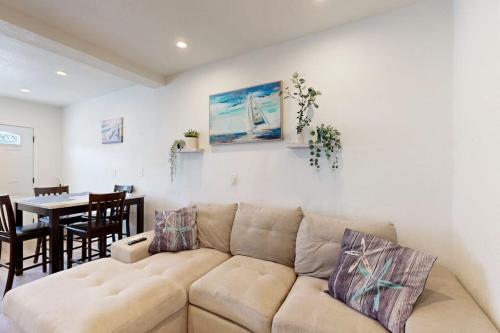 a living room with a couch and a dining room at Fair Weather in Newport Beach