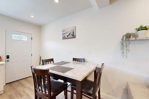 a dining room with a table and chairs at Fair Weather in Newport Beach