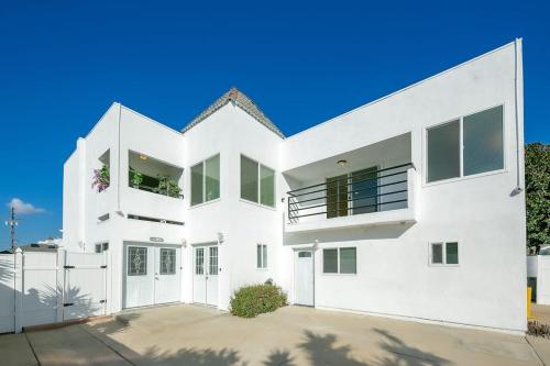 a white house with a large driveway at Sunny Days in Newport Beach