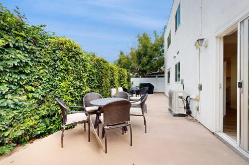 a group of chairs and tables on a patio at Sunny Days in Newport Beach