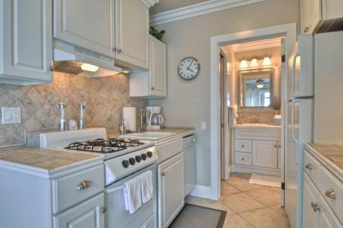 a kitchen with white cabinets and a stove top oven at San Clemente - Monterey D in San Clemente