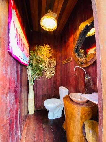 a wooden bathroom with a toilet and a sink at Casa Quietude - Manaus - Manacapuru in Manacapuru