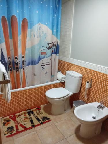 a bathroom with a toilet and a shower curtain at Snow Dreams in Sierra Nevada