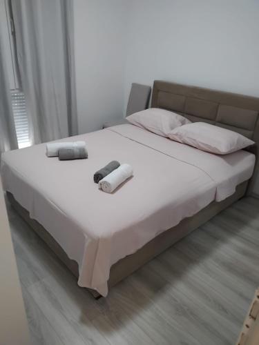 a bed with two towels and two pillows on it at Apartman Mila in Split