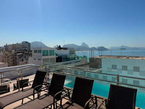 a group of chairs sitting on top of a building at Rio Design Copacabana Hotel in Rio de Janeiro