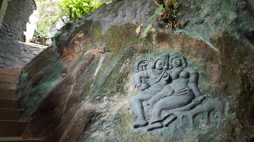 a bas relief of two women on a rock at Ridee Villa in Unawatuna