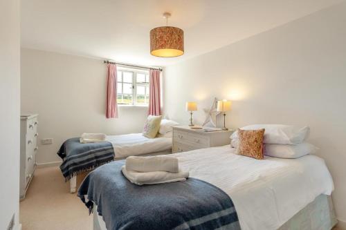 a bedroom with two beds and a window at 3 Bed in Dunwich oc-atc2 in Dunwich