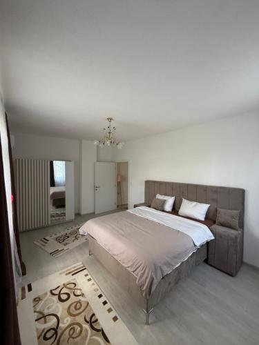a bedroom with a large bed and a couch at Villa Noir Sarajevo in Sarajevo
