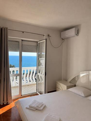 a bedroom with a bed and a view of the ocean at Apartments Buena Vista in Ulcinj