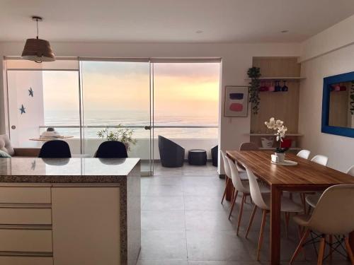 a kitchen and dining room with a view of the ocean at Beach view apartment Punta Hermosa 4BR in Punta Hermosa