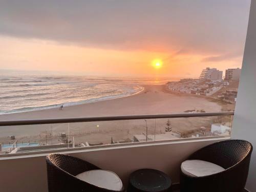 a room with a view of a beach and the ocean at Beach view apartment Punta Hermosa 4BR in Punta Hermosa