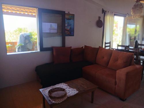 a living room with a couch and a table at Tigre Beach House in Trairi