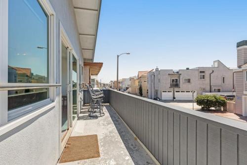 a balcony with a view of a street with buildings at Upper Level Beach Retreat in Newport Beach