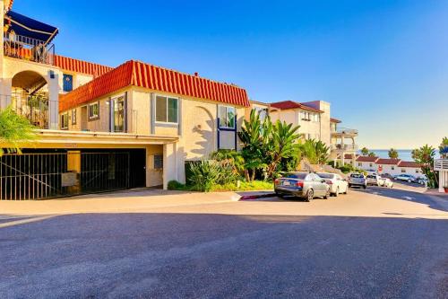 a house with cars parked in a parking lot at Pier View Paradise in San Clemente