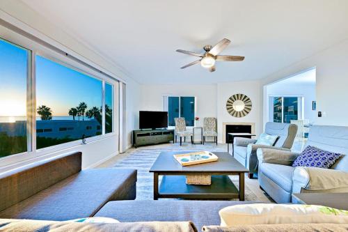a living room with a couch and a table at Pier View Paradise in San Clemente