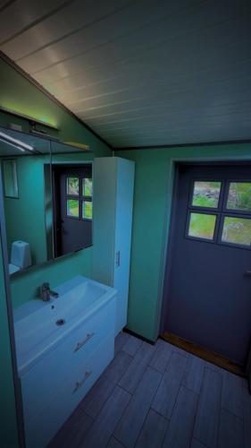 a bathroom with a sink and a mirror at BAPA STAYs in Kristianstad