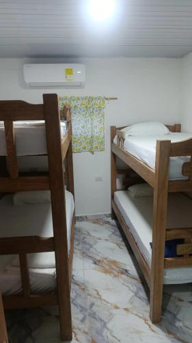 a room with three bunk beds in a room at Los Clemones in Rincón