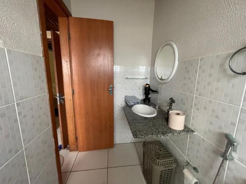 a bathroom with a sink and a mirror at Flat Amarração Shopping in Luis Correia
