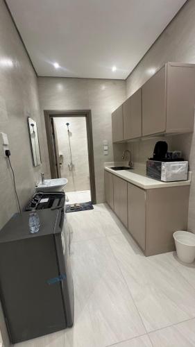 a kitchen with a sink and a counter in it at سويت بغرفة نوم شوحط in Abha