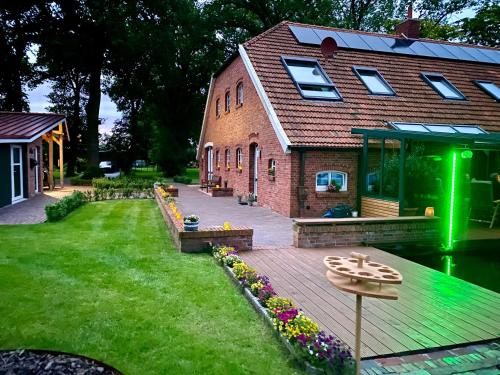 a house with a deck next to a building at Ferienwohnung Marita 35681 in Uplengen