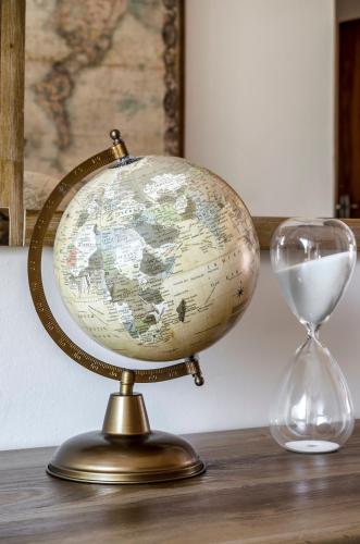 an old globe and an hourglass on a table at Admirals Lodge Guest House and Brightways self catering apartments in Port Elizabeth