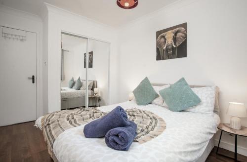 a bedroom with a bed with blue towels on it at BrightCentral Apartment With Parking in Glasgow
