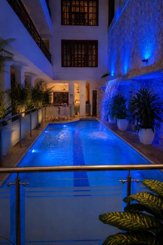 a swimming pool in a house at night at Hotel Casa Esmeralda in Cali
