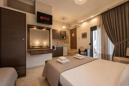a hotel room with a bed with towels on it at Kladis Club Holidays in Skala Potamias