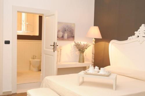a bedroom with a bed and a table with a lamp at Casa Blanca in Reggio Calabria