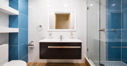 a bathroom with a sink and a shower at Hotel Plaza Tapatia in Guadalajara