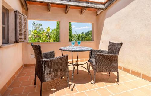 a patio with a table and chairs and windows at Estrella - Son Jorbo in Porreres