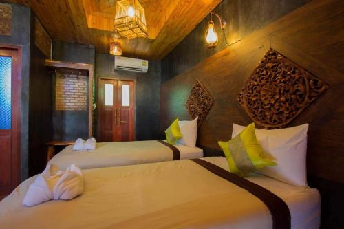 a bedroom with two beds in a room at Sea Rock Resort in Haad Pleayleam