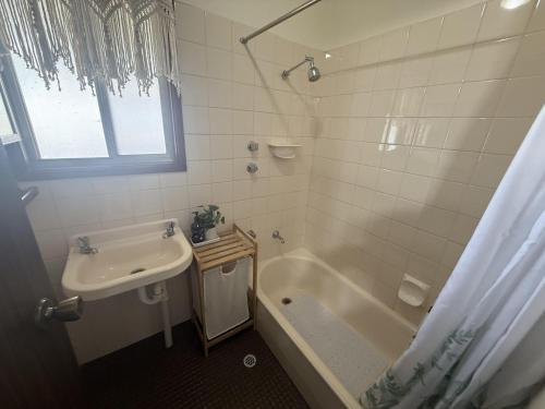 a bathroom with a tub and a sink and a shower at Flahertys Retreat in Point Turton
