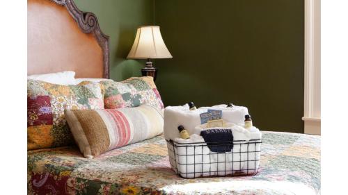 a basket sitting on a bed next to a lamp at Remington in Cimarron