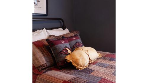a dog laying on top of a bed at Fred Lambert in Cimarron