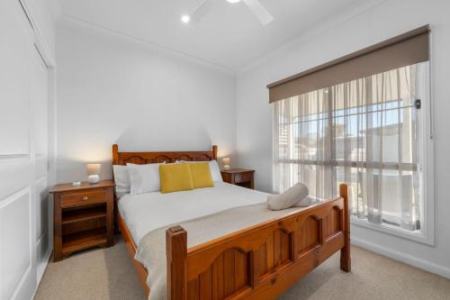a bedroom with a bed and a large window at 15B Bolton Street in Berridale