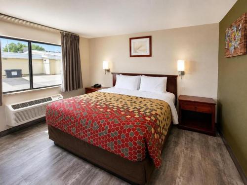 a hotel room with a large bed and a window at Economy Inn in Las Cruces