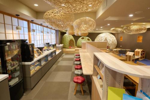 a store aisle with a counter in a store at Hana Beppu in Beppu