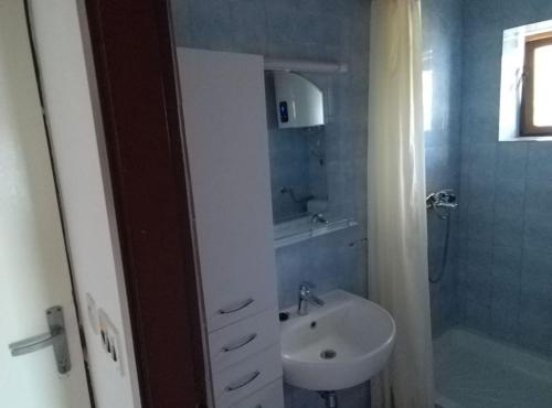 a bathroom with a sink and a toilet and a shower at Casa del Mar Rooms in Lopud