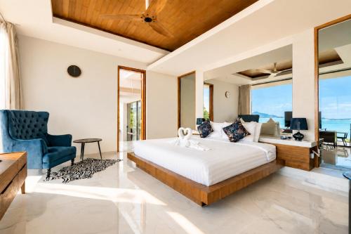 a bedroom with a bed and a desk and a couch at Villa Skyfall Thailand Phuket in Panwa Beach