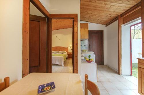 a kitchen with a table and a room with a bed at La rosa dei venti in Procida