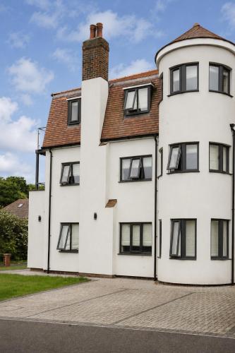 a white house with black windows on a street at Salt Rooms in Scarborough
