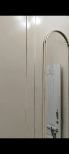 a mirror in a bathroom with a hanger at Relax Holiday Guest House in Kākināda
