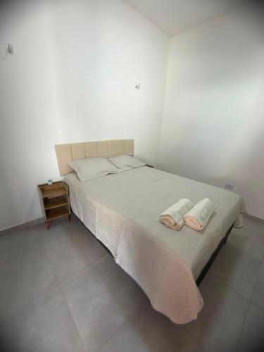 a bedroom with a bed with two towels on it at Casa Dunas douradas in Barreirinhas