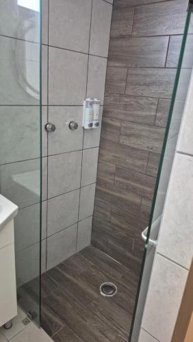 a shower with a glass door in a bathroom at Your Perfect Rest Apartment with Pool and AC in Playa de Vacas