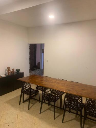 a large wooden table with chairs in a room at Hostel e Camping Terapia Roots in Santa Teresinha